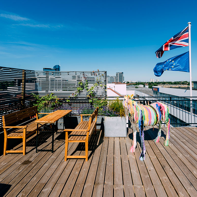 Union Jack and EU flag flying on the Catch London factory rooftop on a sunny day