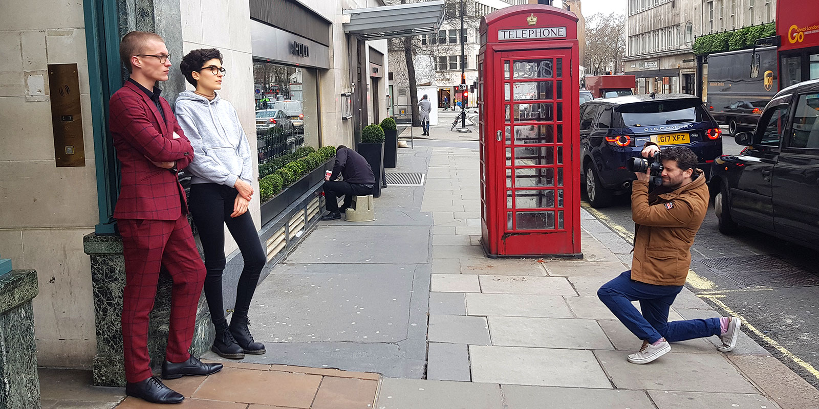 Two Catch London models being photographed in front of red phone booth for Boots 2019 campaign