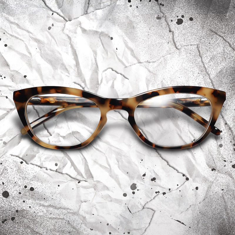 Emma Stone as Cruella wears glasses in Disney's Cruella, designed by Tom Davies.